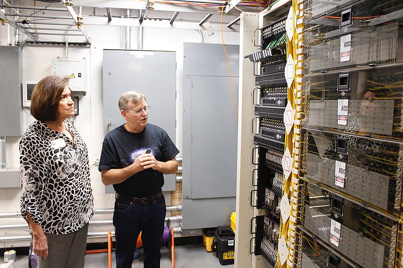 David Wall, Cable ONE's local general manager, right, explains the company's fiber-optic internet infrastructure to Texarkana, Ark., Mayor Ruth Penney-Bell during a tour of facilities Friday in Texarkana, Texas. Cable ONE launched its GigaONE service for the Texarkana regional market with a promotional party Friday at its offices. GigaONE promises download speeds of 1 gigabit per second.