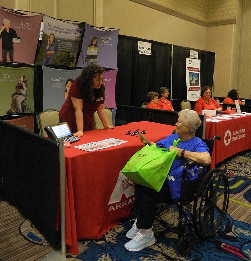 Elizabeth McLoud learns about telephone services from Arkansas Relay Services Friday morning, June 1, 2018, at the annual Senior Health and Wellness Expo. (Staff photo by Lori Dunn)