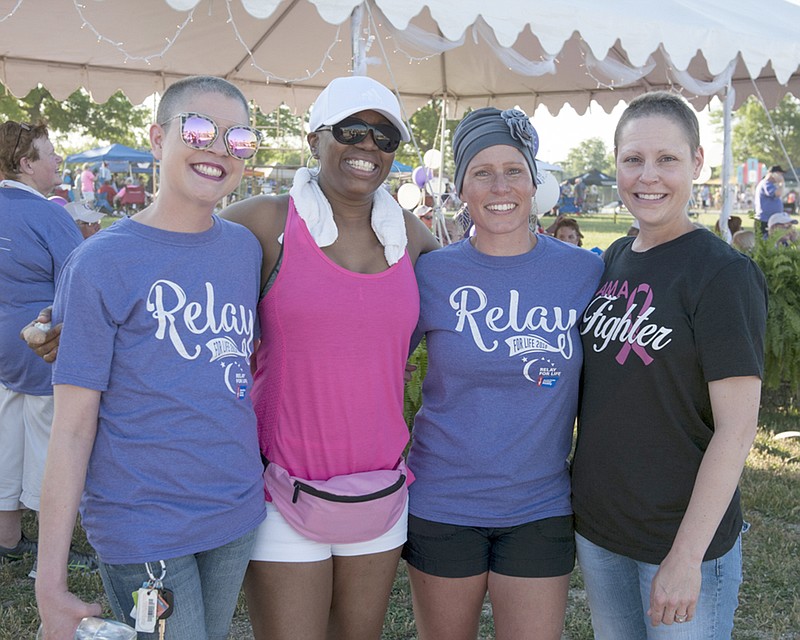 From left, Lindsay Hess, Liz Morrow, Amber Meyer and Amanda Bock gather for a photo Friday at the Relay for Life at the Jefferson City Jaycee Fairgrounds. The four women are connected through their fight against cancer and are supporting each other as they go through chemo, surgery and radiation treatments. Previously strangers, they met through social media and a chance encounter at a gas station.
