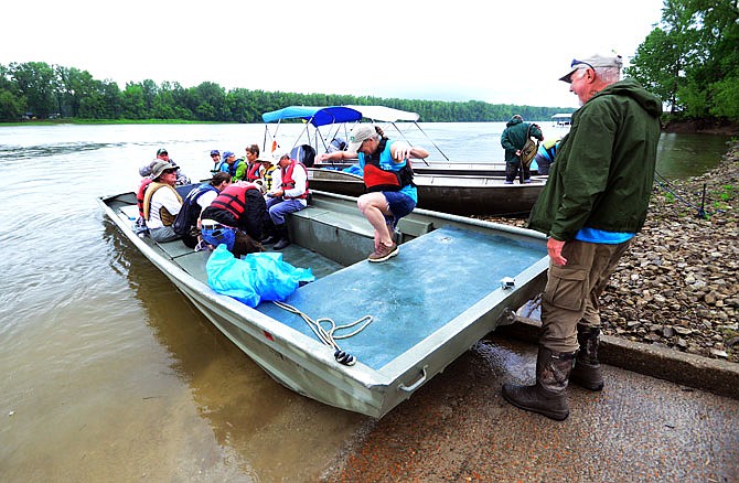 Following an early morning thunderstorm Saturday, June 2, 2018, Missouri River Relief volunteers board boats at Bonnots Mill to pick up trash along the Osage and Missouri rivers in a community-wide, cleanup effort. 