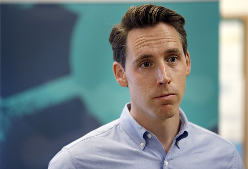 FILE - In this May 25, 2018, file photo, Missouri Attorney General and Republican U.S. Senate candidate Josh Hawley takes questions from the media after touring an ethanol plant in Macon, Mo. The end of Missouri Gov. Eric Greitens' tenure as governor Friday, June 1, 2018, could breathe new life into Hawley's campaign. He's seeking to unseat Democratic Sen. Claire McCaskill in what's expected to be one of the most contentious races in the nation, a challenging task not helped by turmoil in the governor's office. (AP Photo/Jeff Roberson, File)