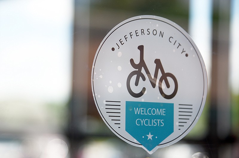 A new decal advertising a "Cyclist Friendly Business" is visible in a window Thursday at Schnucks.