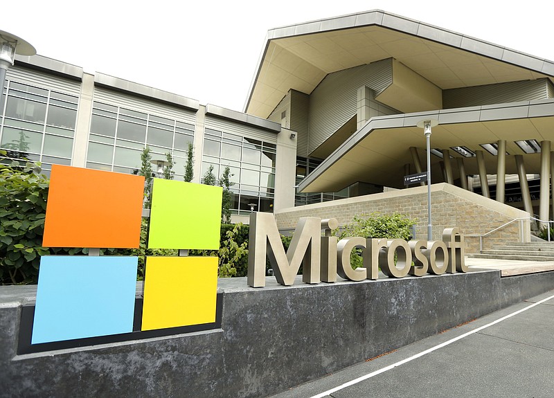 FILE - This July 3, 2014 file photo shows Microsoft Corp. signage outside the Microsoft Visitor Center in Redmond, Wash. Microsoft says it's paying $7.5 billion in stock for the popular coder hangout GitHub. (AP Photo Ted S. Warren, File)