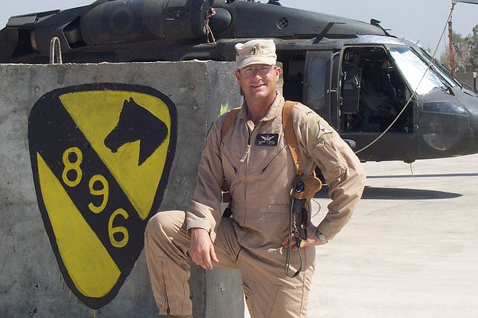 Pat Muenks is pictured in front of his UH-60 "Blackhawk" helicopter on Taji Airfield in Taji, Iraq, in 2004. During the deployment, the pilot was briefly attached to 2nd Battalion, 227th Aviation Regiment.