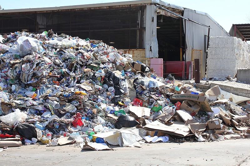 This March 2018 file photo shows material collected by Waste Management's curbside, single-stream recycling service awaiting transport to a Shreveport, Louisiana, sorting facility at a Caraustar Industries plant in Texarkana, Texas.