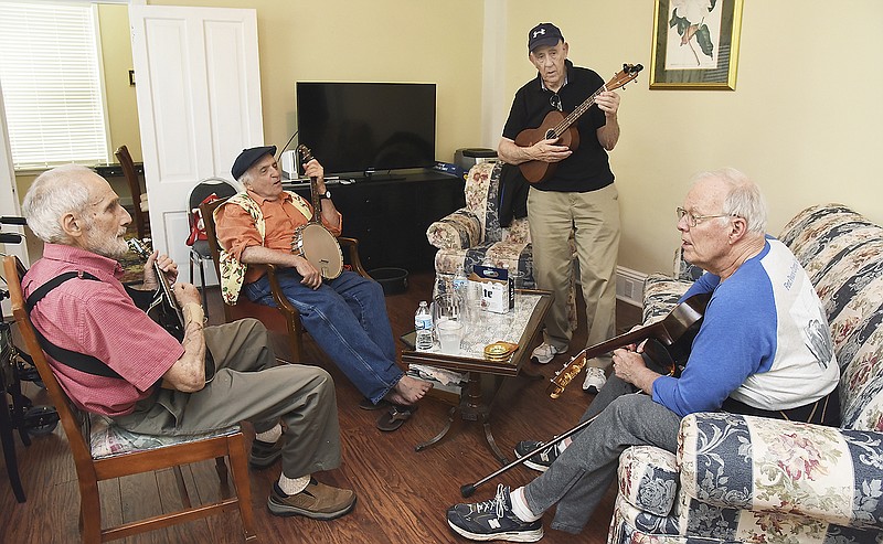 Several men who were in the first wave of Peace Corps volunteers gathered for a reunion this week to share stories and reminisce. They also share some musical talent and played a few songs from the 1960s period. From left, Peter De Simone, Lenny Bloom, Burton Segall and George Johnson all on strings playing "Where have all the Flowers Gone." They talked about the experiences that helped form them and the direction in life it caused them to take.