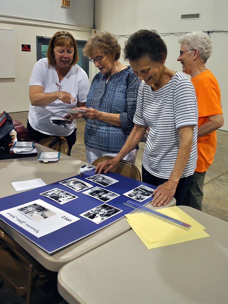 From left, Janice Roush, Linda Harrison, Carolyn Nichols and Darlene Gipfin enjoy looking at photos from past vacation bible schools at First Baptist Church of Elston during a meeting June 5. The ladies have helped research and gather town historical information and artifacts for the Cole County Historical Society's the first 2018 Getting to Know Our Communities program June 19 at the church's activity building in Elston.