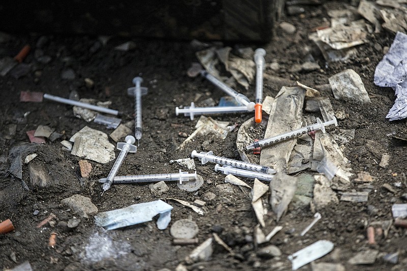 FILE - This Feb. 2, 2017 file photo, shows used needles littering the ground along train tracks in Philadelphia's largest open air drug market in the Kensington section of the city. A government study released on Thursday, June 7, 2018, found that heroin addicts and other injection drug users were 16 times more likely than other people to develop the staph infection MRSA. (Michael Bryant/The Philadelphia Inquirer via AP)
