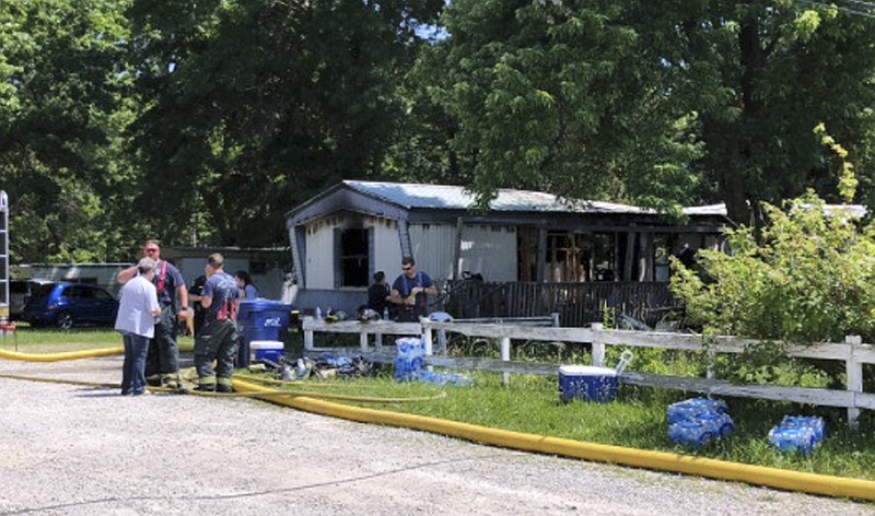 This photo from video by KYTV in Springfield, Mo., shows emergency personnel at the scene in Lebanon, Mo., Wednesday, June 6, 2018, where multiple children died and a woman was injured in a mobile home fire. (Andrew Havranek/KYTV via AP)