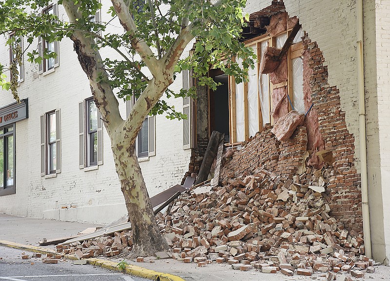 Emergency personnel blocked off the area after bricks fell from a law office building at the corner of Madison and East High streets in downtown Jefferson City on Thursday, June 7, 2018.