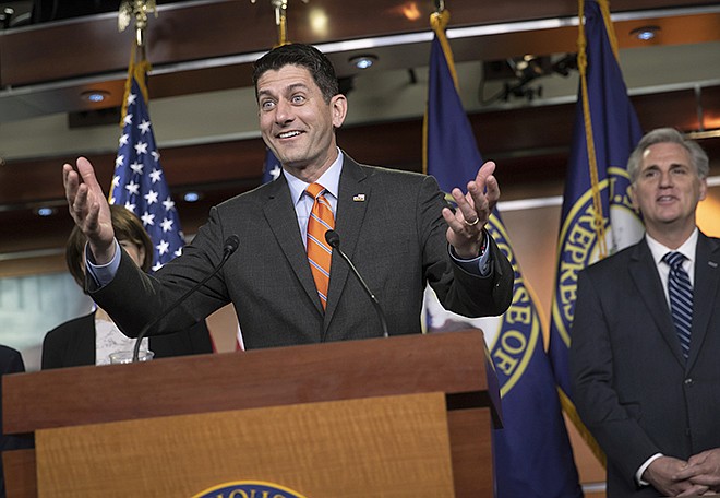 FILE - In this May 16, 2018 file photo, Speaker of the House Paul Ryan, R-Wis., with Majority Leader Kevin McCarthy, R-Calif., at right, has a light-hearted exchange with reporters at the start of a news conference on Capitol Hill in Washington.  A bipartisan group is urging lawmakers to use House Speaker Paul Ryan's upcoming retirement from the House of Representatives as a moment for reform.