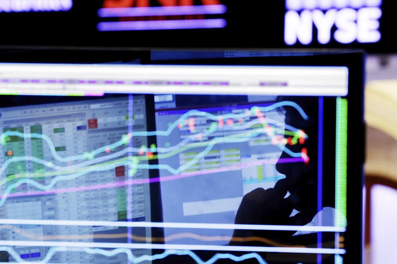 FILE - In this Jan. 11, 2016, file photo, specialist Anthony Rinaldi is silhouetted on a screen at his post on the floor of the New York Stock Exchange. Fears of a trade war have given a boost to some of the biggest companies in the market as well as the smallest, but they’ve squeezed almost everything in the middle. (AP Photo/Richard Drew, File)