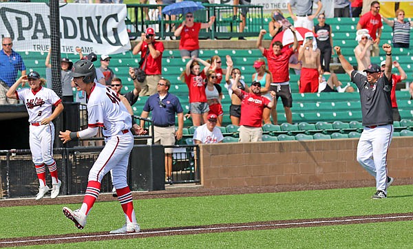 Jays coach Brian Ash (far right) throws his arms in the air as Gunnar See of Jefferson City walks to home plate for the winning run in the eighth inning of the 2017 Class 5 state championship game at CarShield Field in O'Fallon.