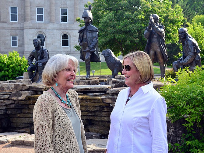 Sculptor Sabra Tull Meyer, left, and daughter Sabra Johnson talk in front of the Lewis and Clark Trailhead Plaza monument on Thursday during the 10th anniversary celebration of its completion.