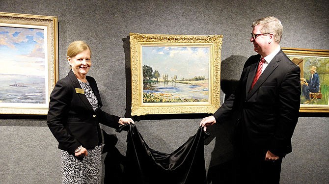 Unveilng a newly acquired Winston Churchill painting on Friday were Anne Weller, president of the Mid-Missouri Friends of the National Churchill Museum, and Tim Riley, director and chief curator of the museum. The painting was gifted by the Monsanto Company.