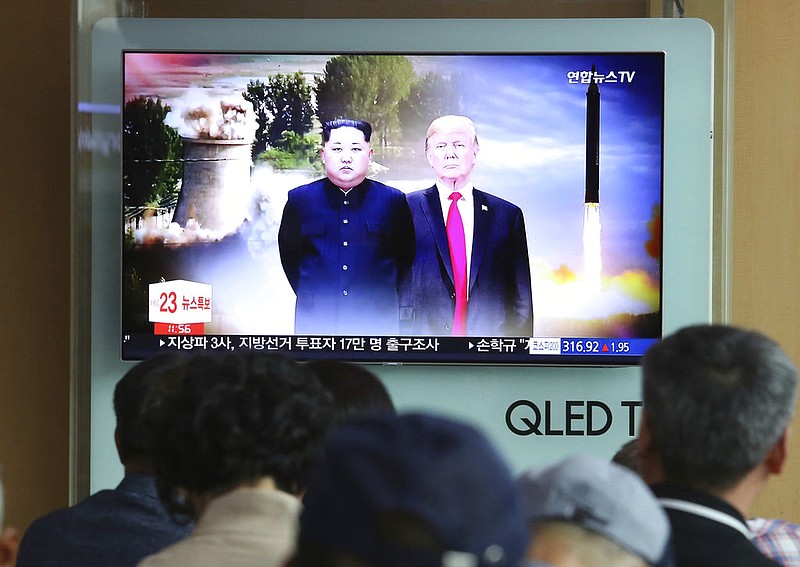 People watch a TV screen showing file footage of U.S. President Donald Trump, right, and North Korean leader Kim Jong Un during a news program at Seoul Railway Station in Seoul, South Korea, Monday, June 11, 2018. Final preparations are underway in Singapore for Tuesday's historic summit between President Trump and North Korean leader Kim, including a plan for the leaders to kick things off by meeting with only their translators present, a U.S. official said.