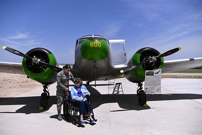 In a May 26, 2018 photo, Senior Airman Tiffany Schockley of Dyess Air Force Base waits with Dorothy Lucas in front of a Cessna UC-78 Bobcat at the WASP Homecoming in Sweetwater, Texas. Lucas was a member of the Women's Airforce Service Pilots and trained at Avenger Field in 1944. (Ronald W. Erdrich/The Abilene Reporter-News via AP)