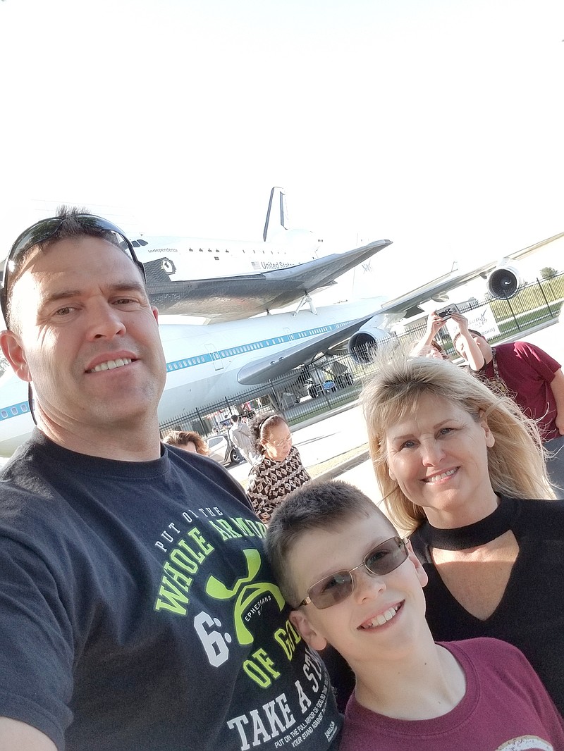 Marty Graham, left, takes a selfie with his son Luke and wife Nancy during the FIRST Championship robotics competition in April.