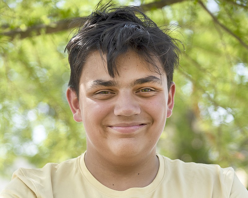 Jacob Gladbach poses for a portrait Monday on Monroe Street. In May, Jacob was diagnosed with ALD and will be heading to St. Louis for a bone marrow transplant to help combat the genetic disease.