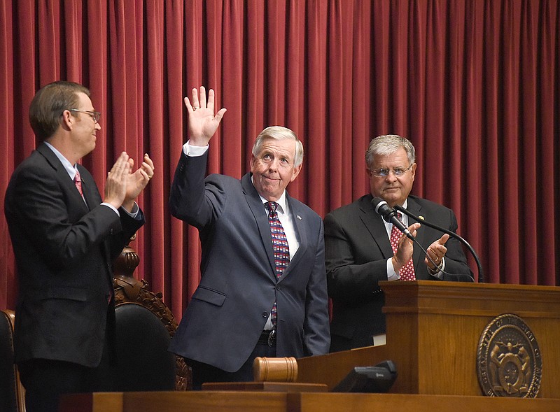 Gov. Mike Parson waves to crowd members Monday after giving his first address in the House chamber at the Capitol. 