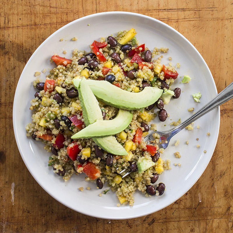 This undated photo provided by America's Test Kitchen in May 2018 shows a quinoa, black bean and mango salad in Brookline, Mass. This recipe appears in the cookbook "Vegan For Everybody." (Daniel J. van Ackere/America's Test Kitchen via AP)