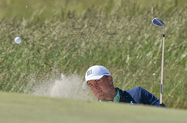 Jordan Spieth hits out of a bunker onto the eighth green during Tuesday's practice round for the U.S. Open at Shinnecock Hills in Southampton, N.Y.