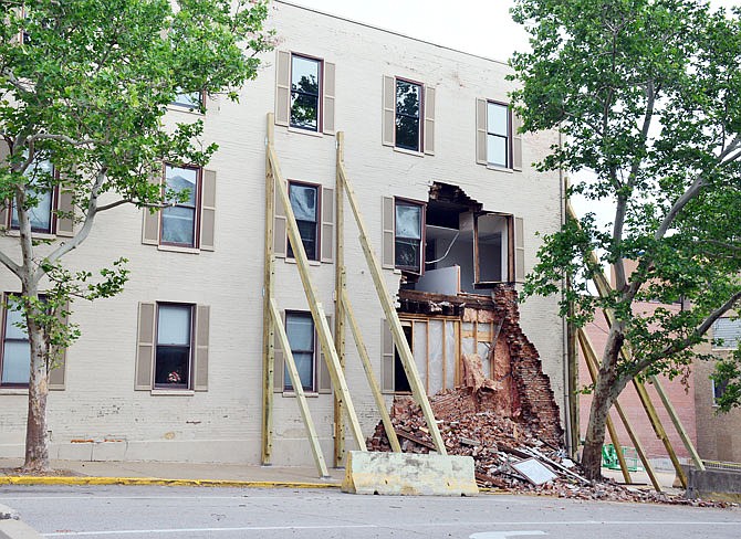 A barricade surrounds the law office building at the corner of Madison and East High streets in downtown Jefferson City following a partial collapse recently.