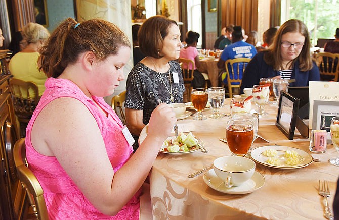 After learning how to set a table for a formal occasion, local youth from Big Brothers Big Sisters, Boys & Girls Club of Jefferson City along with some foster children, including Kristin Kilby, left, Madison Head, right, and Nicki Jungmeyer, were seated for a lunch Tuesday. About two dozen children were guests for the day's Manners at the Mansion class sponsored by Friends of the Missouri Governor's Mansion. 
