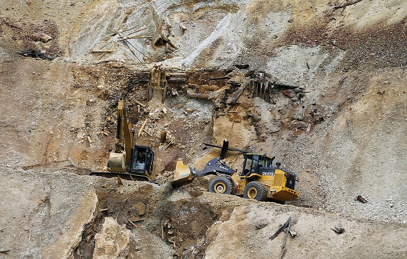 FILE - In this Aug. 12, 2015, file photo, Environmental Protection Agency contractors repair damage at the site of the Gold King mine spill of toxic wastewater outside Silverton, Colo. The Gold King and other mines in the area are now part of a Superfund cleanup project. The U.S. Environmental Protection Agency announced Thursday, June 14, 2018, it plans to take a series of interim cleanup steps at some of the sites while it searches for a longer-term solution. (AP Photo/Brennan Linsley, File)