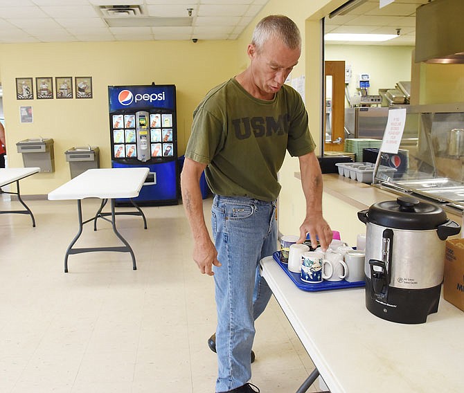 Jay Williams, an occasional resident at The Salvation Army Center of Hope, helps prepare for the day's lunch crowd Wednesday at the Jefferson Street center. Due to the recent high temperatures, Williams also uses the facility for a cooling station during the heat of the day. The Center of Hope is listed as a local cooling station, along with Missouri River Regional Library and Capital Mall.