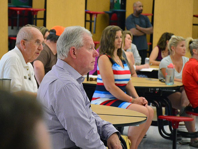 Concerned residents listen to Jefferson City Superintendent Larry Linthacum on Wednesday as he discusses options for boundary line changes during a public meeting at Lewis and Clark Middle School. 