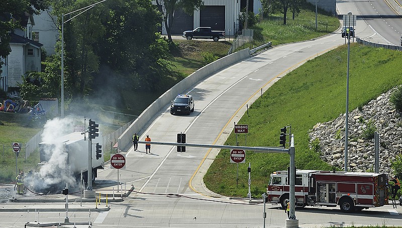 Jefferson City firefighters responded to the scene of a vehicle fire on the westbound U.S. 50 exit ramp to Lafayette Street on Thursday, June 14, 2018. Officers from the Jefferson City Police Department blocked lanes of traffic for safety purposes.