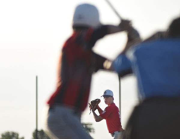 Jefferson City Post 5 Juniors pitcher Cade Stockman eyes his target before firing a pitch during Wednesday night's game against the Central Missouri Phenom at the American Legion Post 5 Sports Complex.