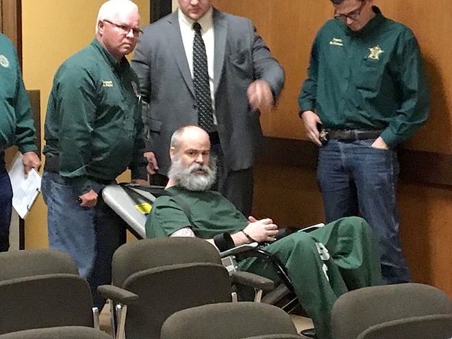 Reggie Smith is cuffed, strapped into a restraint chair and wheeled into a Bowie County courtroom Wednesday morning, June 13, 2018. Smith refused to enter the courtroom on his own for a trial on a charge of burglary of a habitation with intent to commit assault. Once in the courtroom, Smith began hurling obscenities at 102nd District Judge Bobby Lockhart and was removed from court for most of the proceedings.