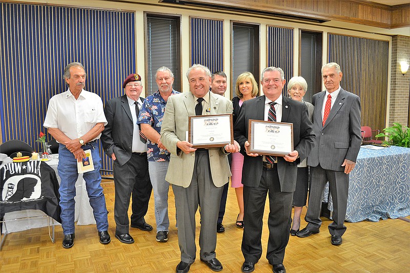 Texarkana Gazette journalist Greg Bischof and Navy veteran Bill Norton pose with their Chapel of Four Chaplains Legion of Honor Awards Thursday evening during a ceremony at Texarkana College. Behind them are past recipients of the honor. (Photo by Kate Stow)