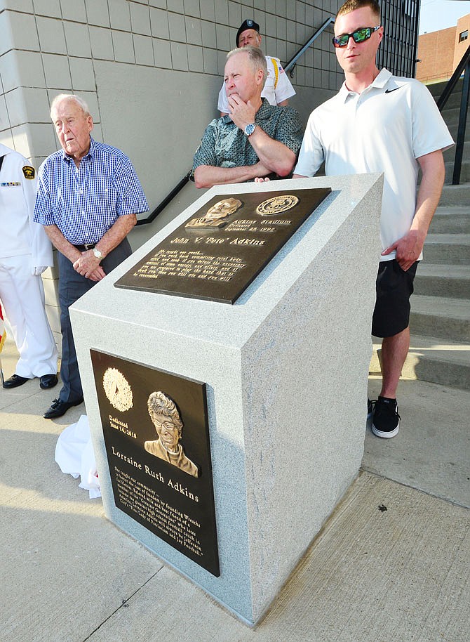 Three generations of Adkins men unveil a memorial honoring the late Lorraine Adkins, during a ceremony Thursday at Jefferson City High School. Coach Pete Adkins was joined by son Terry and grandson Blake.
