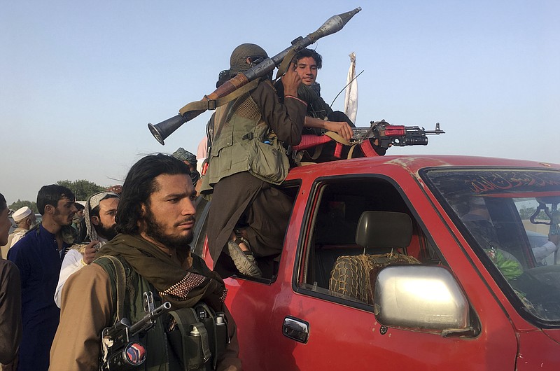Taliban fighters ride in their vehicle in Surkhroad district of Nangarhar province, east of Kabul, Afghanistan, Saturday, June 16, 2018. A suicide bomber blew himself up in eastern Afghanistan on Saturday as mostly Taliban fighters gathered to celebrate a three-day cease fire marking the Islamic holiday of Eid al-Fitr, killing 21 people and wounding another 41, said the Nangarhar provincial Police Chief Ghulam Sanayee Stanikzai. Most of the dead and wounded were believed to be Taliban, he said. (AP Photo/Rahmat Gal)