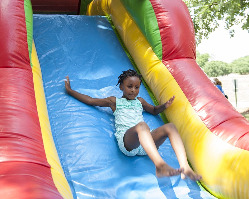 
D'Naya Duckworth, 5, does a summersault down an inflatable slide at the Juneteenth Heritage Festival at Ellis-Porter Park on Saturday, June 16, 2018.