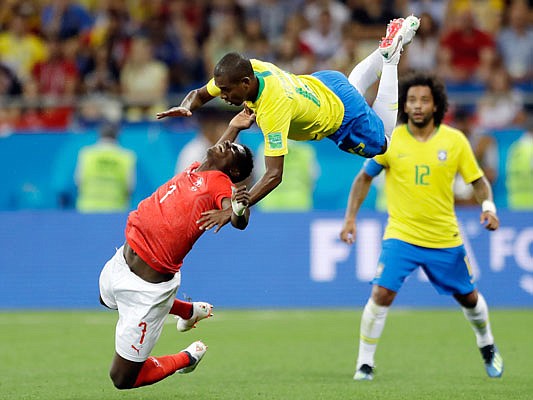Switzerland's Breel Embolo (left) and Brazil's Fernandinho fall during a collision in a Group E match Sunday in Rostov-on-Don, Russia.