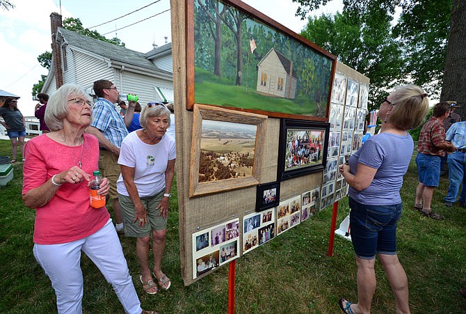 The Schmoeger Farm in Russellville held a celebration Saturday to observe their century mark. The Schmoeger siblings threw the shindig for family and friends who, in addition to being well fed, got a chance to learn the history and lineage of the farm through stories and photographs. Shown in the foreground above looking at the display are, from left, Doris Seidel, Candace Stockton and Debbie Linsenbardt.