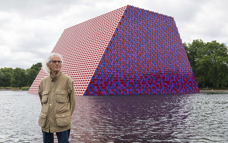 Artist Christo attends the unveiling of his first UK outdoor exhibit, The London Mastaba, on the Serpentine Lake in Hyde Park, central London, Monday June 18, 2018. The sculpture consists of 7,506 horizontally stacked barrels on a floating platform in the lake. (Dominic Lipinski/PA via AP)