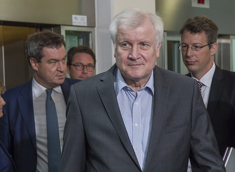 German Interior Minister and Christian Social Union, CSU, party chairman Horst Seehofer, center, arrives with party's General Secretary Markus Blume, right and Bavarian Prime Minister Markus Soeder, left, for a board meeting of the CSU in Munich, Monday, June 18, 2018. ( Peter Kneffel/dpa via AP)