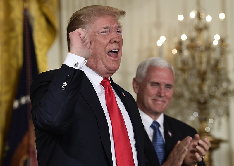 President Donald Trump speaks at the beginning of a National Space Council meeting in the East Room of the White House in Washington, Monday, June 18, 2018, as Vice President Mike Pence looks on. (AP Photo/Susan Walsh)
