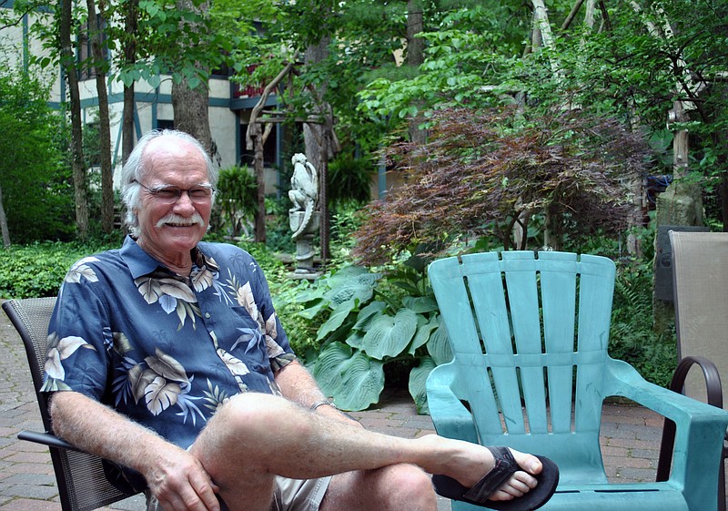 Retired dentist Jim Jecman lounges at one of his favorite gathering spots in the middle of his now award-winning home garden, which earned the Bittersweet Garden Club's June Garden of the Month.