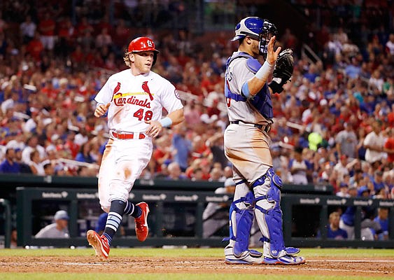 Harrison Bader of the Cardinals scores past Cubs catcher Willson Contreras during the sixth inning of Sunday night's game at Busch Stadium.