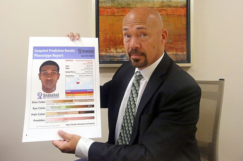 Private investigator Jason Jensen holds a phenotype report at his office Friday in Salt Lake City. Groups of private investigators in Utah and California have been emboldened by the arrest of the suspected Golden State Killer and are spearheading a push to replicate authorities' use of DNA evidence in that case by urging amateur genealogists to contribute genetic information to a public DNA database, despite concerns about privacy.