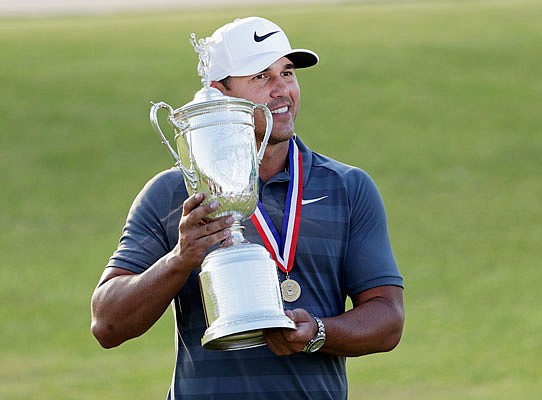 Brooks Koepka holds the trophy Sunday after winning the U.S. Open in Southampton, N.Y.