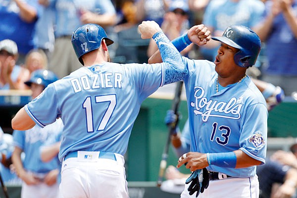 Hunter Dozier celebrates with Royals teammate Salvador Perez after hitting a two-run home run in the third inning of Sunday afternoon's game against the Astros at Kauffman Stadium.