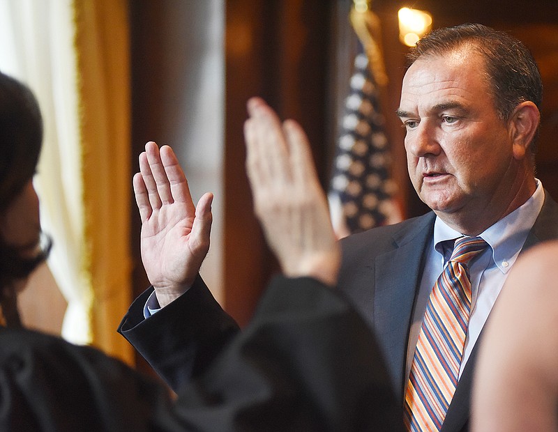 Mike Kehoe recites the oath Monday to become the next lieutenant governor during a press conference in the governor's office at the state Capitol.