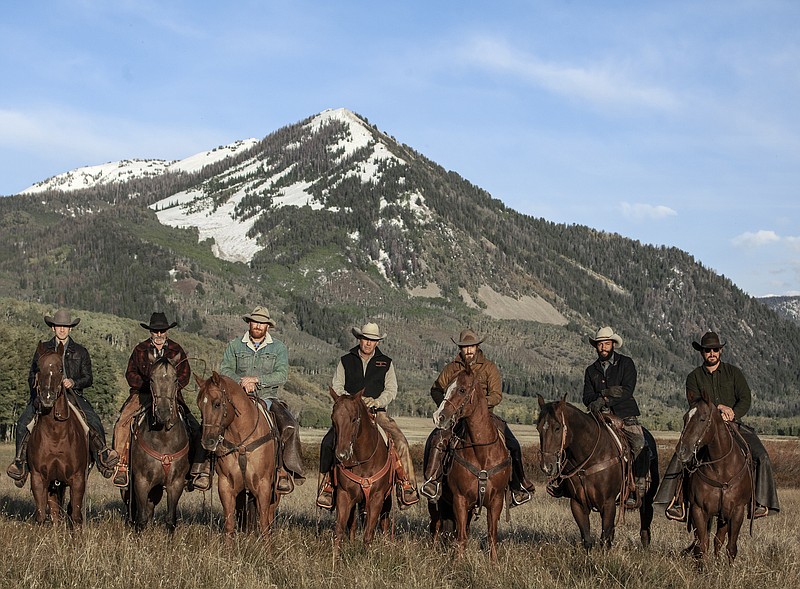 This image released by Paramount Network shows, from left, Wes Bentley, Forrie Smith, Luke Peckinpah, Kevin Costner, Dave Annable, Denim Richards and Cole Hauser from the series "Yellowstone," premiering Wednesday, June 20. (Paramount Network via AP)